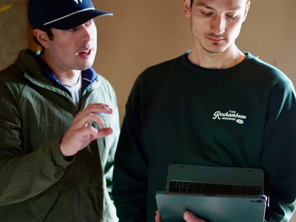 Lyle and Domenic reviewing plans on a tablet