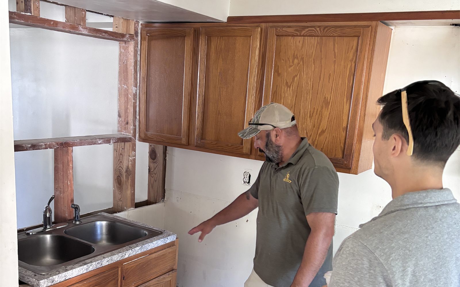 Walking a gutted kitchen with a contractor during the renovation