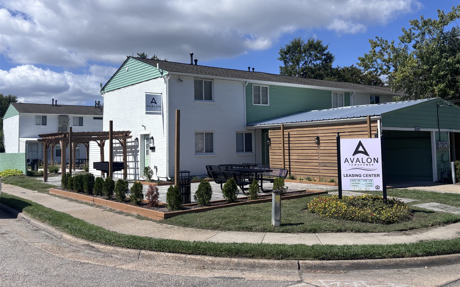 Avalon's renovated leasing center with a new patio, pergola and sign