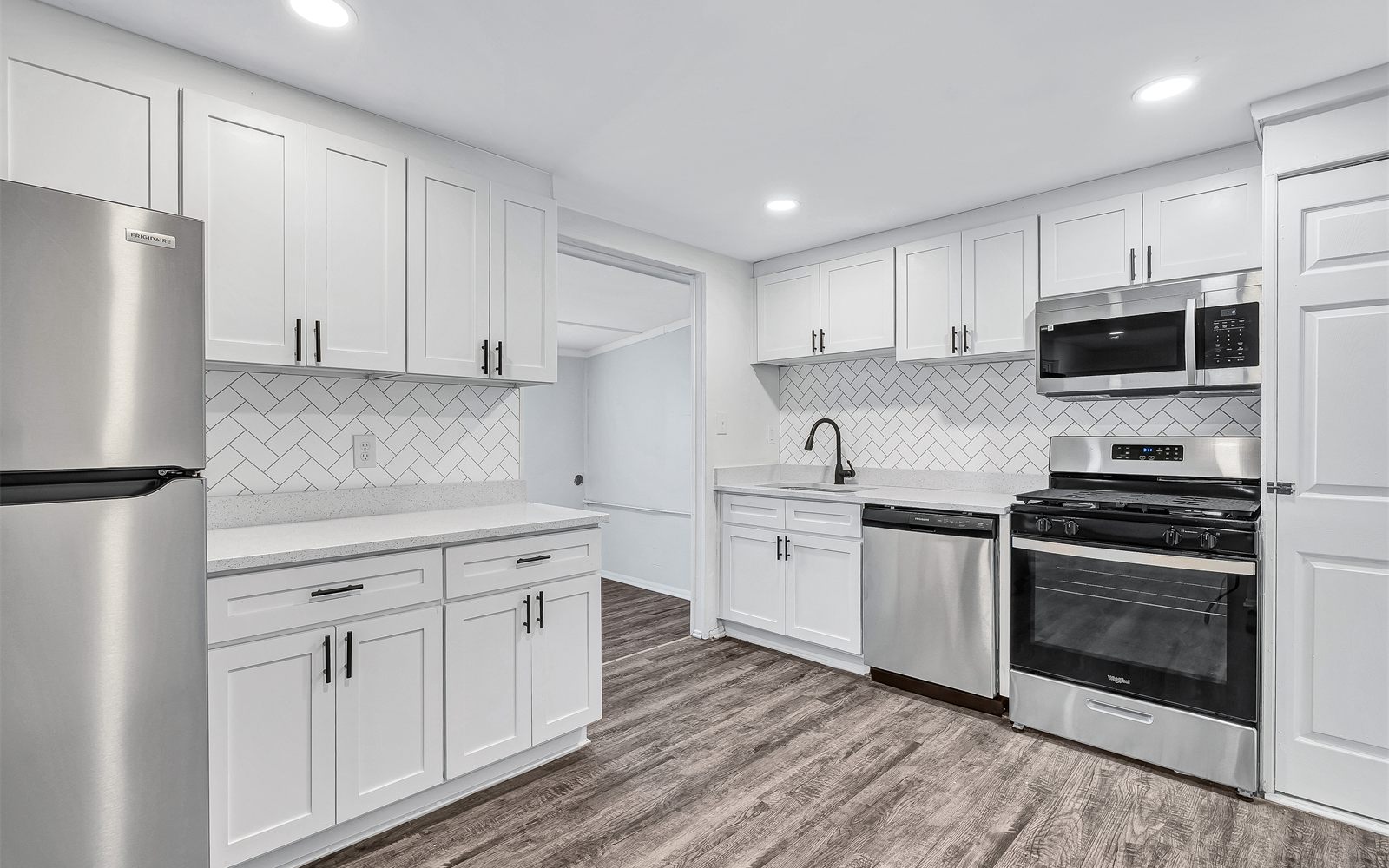 A renovated Avalon kitchen with white cabinets and stainless appliances