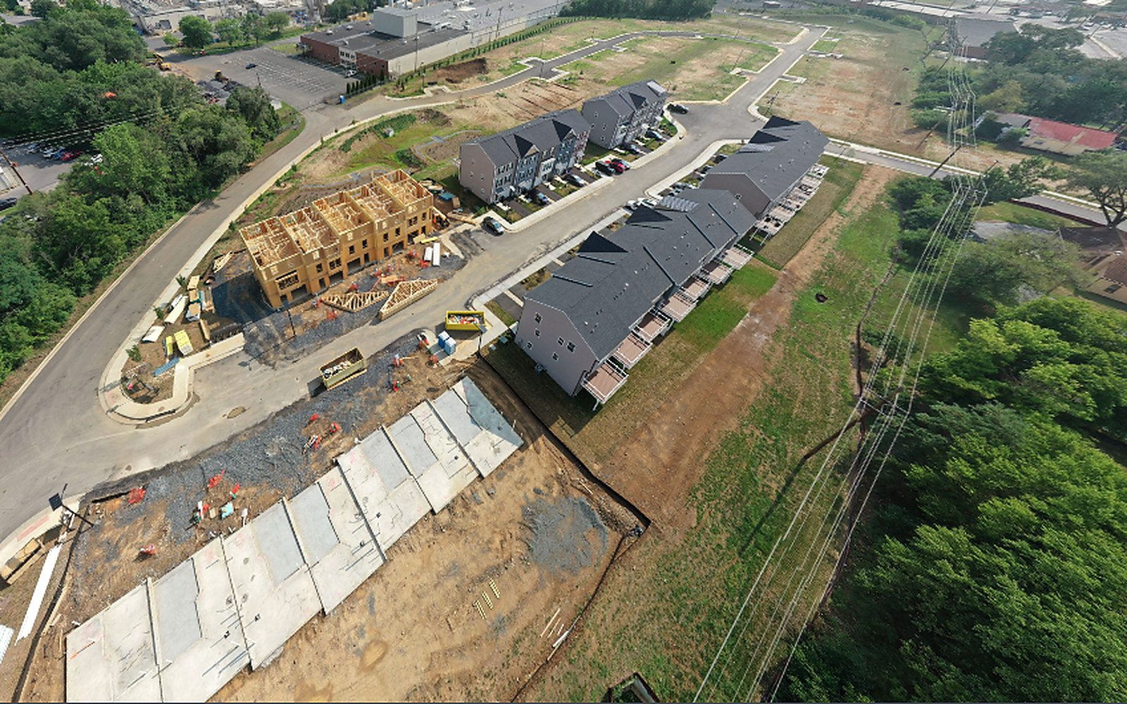 Aerial view of Village at Valor Crossing under construction, with the first rows of townhomes finished